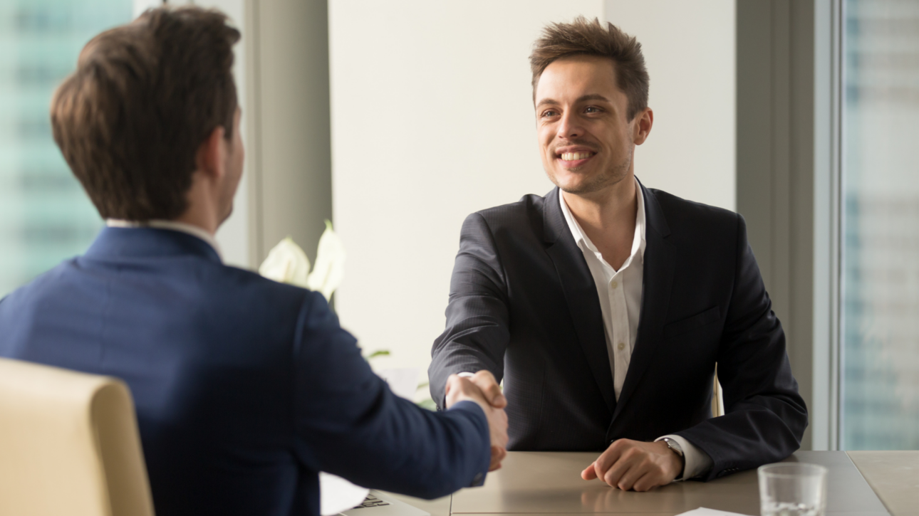 Relatiebeheerder in adviesgesprek met een ondernemer aan tafel op kantoor